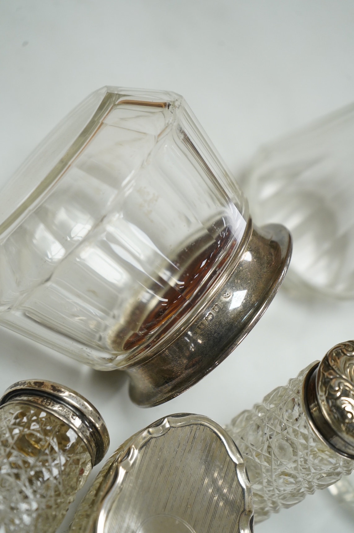 Three George V silver and tortoiseshell mounted glass toilet jars, Adie Brothers, Birmingham, 1925 & 1927, together with three other silver mounted glass toilet jars.